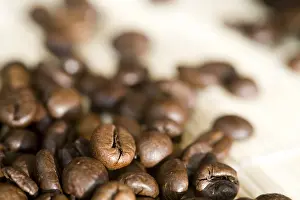 Freshly Roasted Coffee Beans Prints: Coffe beans with focus in the left front corner