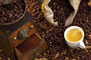 Coffee Grinder Prints: Many coffee beans lying next to a coffee grinder
