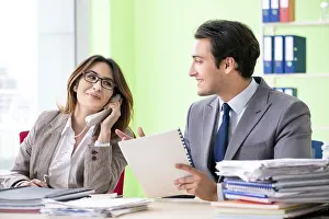 Manpower In Action Prints: Two colleagues working in the office