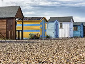 English Channel Coast Prints: Colourful beach huts on the shingle beach