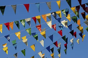 Blue Sky Germany Prints: Colourful triangular flags on a rope in the air and a blue sky in the background
