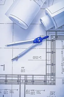 Rolled Blueprints Prints: Compass and two rolled up white blueprints
