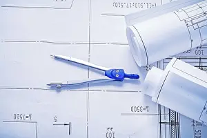 Real Estate Market Prints: Compass and two rolled up white blueprints horizontal version