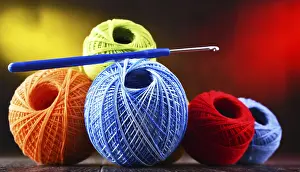 Handicraft Supplies Prints: Composition with assortment of different colored yarns and hook for crocheting