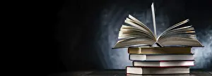 Empty Library Scene Prints: A composition with an open book lying on a stack of other books