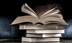 Educational Institution Prints: A composition with an open book lying on a stack of other books