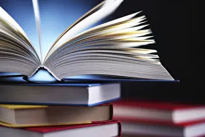 Educational Institution Prints: A composition with an open book lying on a stack of other books