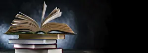 Educational Institution Prints: A composition with an open book lying on a stack of other books
