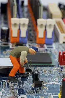 Computer Motherboard Prints: Computer board and worker, symbol photo for computer