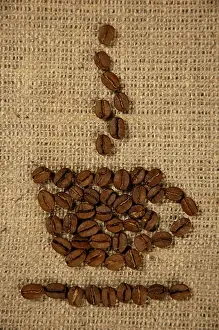 Symbolic Picture Of Breakfast Prints: Conceptual artistic pattern of a cup of coffee made from coffee beans on a sacking background