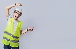 Architectural Style Prints: Construction engineer with vest pointing at an advertisement