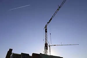 Construction Industry Symbol Prints: Construction site with cranes at nightfall