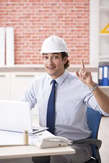 One Person Construction Work Prints: Construction supervisor working on blueprints