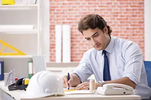 One Person Construction Work Prints: Construction supervisor working on blueprints