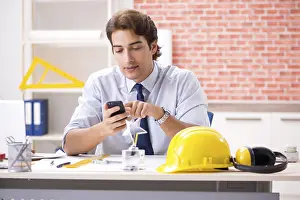 One Person Construction Work Prints: Construction supervisor working on blueprints