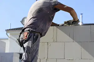 Bricklayer Detail Prints: Construction worker (bricklayer) on the building site