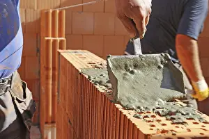Manual Laborer At Work Prints: Construction worker (bricklayer) on the building site