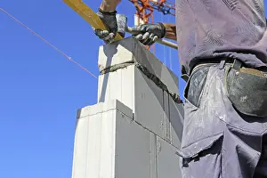 Residential Building Construction Prints: Construction worker (bricklayer) on the building site