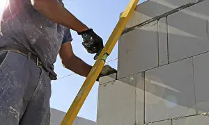 Construction Company Staff Prints: Construction worker (bricklayer) on the building site