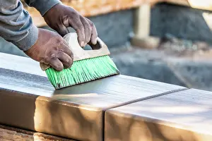 Cement Finishing Techniques Prints: Construction Worker Using Brush On Wet Cement Forming Coping Around New Pool