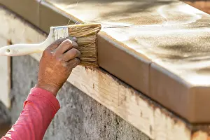 Pool Decking Installation Prints: Construction Worker Using Brush On Wet Cement Forming Coping Around New Pool