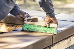 Building A Swimming Pool Prints: Construction worker using brush on wet cement forming coping around new pool