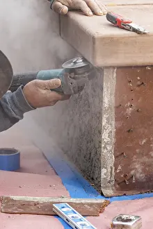 Construction Industry Staff Prints: Construction worker using grinder at construction site