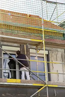 Residential Building Insulation Prints: Construction workers insulate a house facade