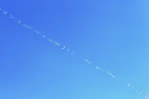 Prints of Contrails form patterns in blue sky, Santorini, Greece Aviation Prints: Contrails Form Patterns in Blue Sky Print