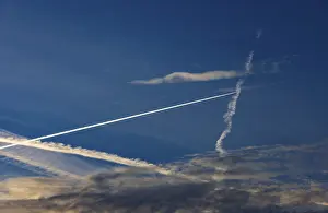 Evening Atmosphere Austria Prints: Contrails intersect in the evening sky
