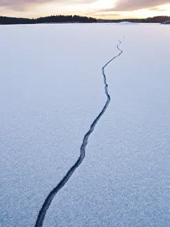 Wintry Countryside Scene Prints: Cracking ice on lake
