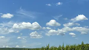 Nice Weather Conditions Prints: Cumulus clouds cluster clouds in front under blue sky
