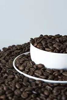 Deserted Coffee Shop Prints: A cup of coffee on coffee beans