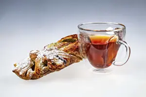 Deserted Breakfast Scene Prints: Cup of tea and cake on an isolated studio background