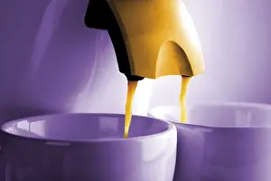 Studio Shot Of Coffee Prints: Two cups of coffee under a coffee machine
