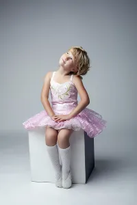 Young Female Dancer Prints: Cute little dancer posing sitting on cube in studio
