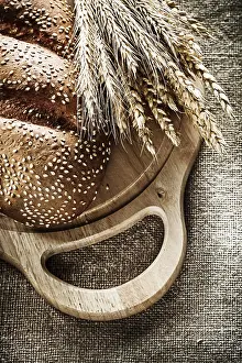 Close Up Bread Roll Prints: Cutting board bread rye ears on burlap background