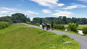 River Valley Scenery Prints: Cyclist on a cycle path by the river