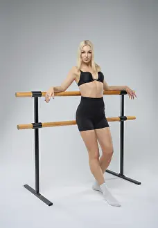 Ballet Dancer Pose Prints: A dancer is posing elegantly at the ballet barre