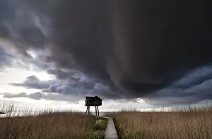 Stormy Atmosphere Photography Prints: Dark storm cloud over observation tower