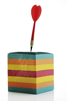Colourful Office Supply Prints: Dart stuck in a stack of multicoloured notepaper