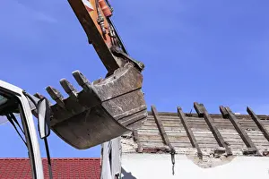 Construction Machinery Prints: Demolition work - an old building is torn down