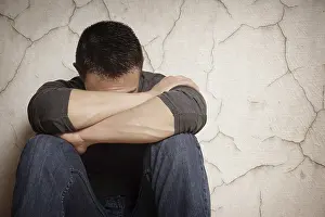 Depressed Young Adult Prints: depression devastated young man hiding his face