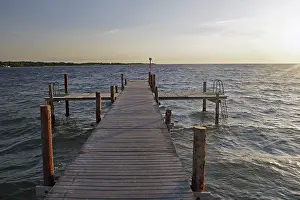 Footbridge Over The Sea Prints: Deserted bathing jetty in the sunset