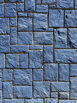 Modern Architectural Design Prints: A detailed image of a blue stone wall featuring interlocking rectangular tiles with a rough texture