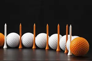 Deserted Golf Scene Prints: Different golf balls on the black table