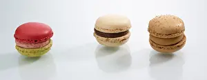 Colorful Desserts Prints: Three differently coloured macarons in front of a white background