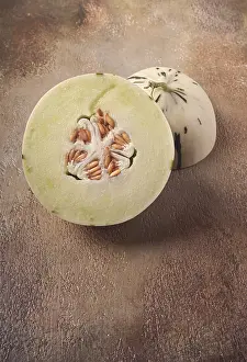 Raw Dessert Ingredients Prints: Dino melon, cut, on the table, top view