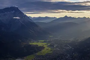 Evening Light In Germany Prints: Distant view of town in front of mountains in the evening light