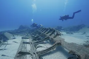 Russian Hydrofoil Wreck Prints: Divers explore a large shipwreck on the ocean floor